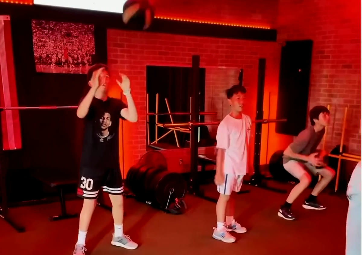 A group of young athletes doing medicine ball work in the Level Up red room